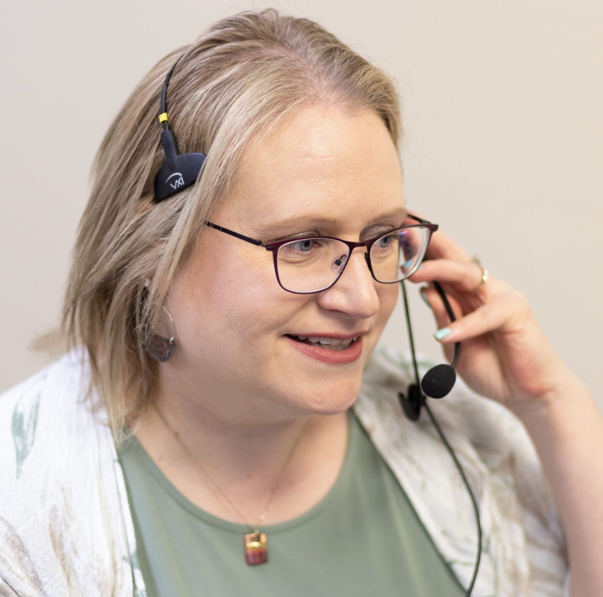 A medical professional with a clipboard talking to another person